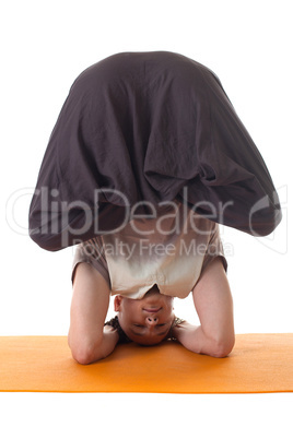 Yoga headstand posing by middle aged man