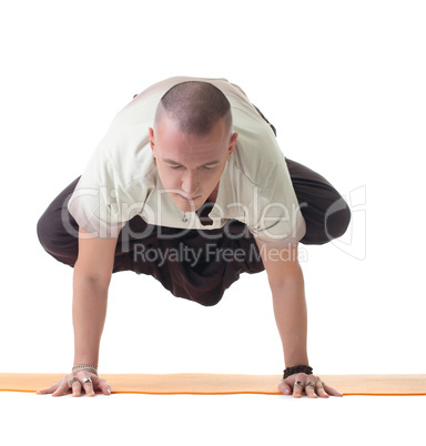 Meditator man doing yoga in studio