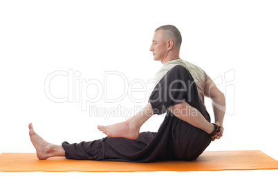 Side view of middle aged man doing yoga in studio