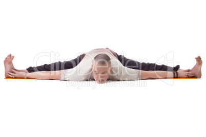 Yogi posing on split, isolated over white backdrop