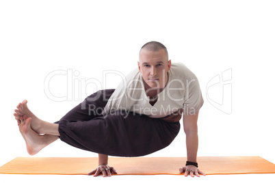 Practicing yoga trainer posing looking at camera