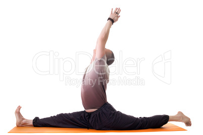 Side view of yoga trainer posing on split