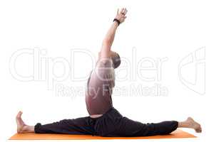 Side view of yoga trainer posing on split