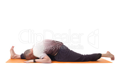 Flexible muscular man in sports wear doing yoga