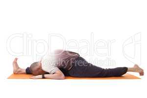 Flexible muscular man in sports wear doing yoga