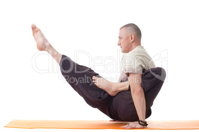 Shot of muscular man posing in difficult asana