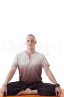 Attractive meditator man posing in lotus posture