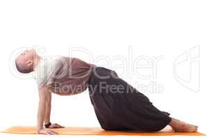 Meditator man doing yoga in loose-fitting clothing