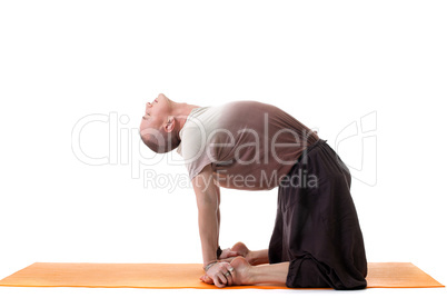 Shot of flexible muscular man doing yoga