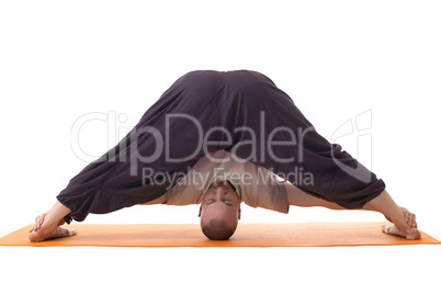 Relaxed man posing in difficult yoga pose
