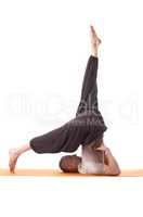 Studio shot of flexible athletic man doing yoga