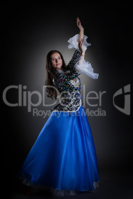 Smiling young brunette dancing in studio