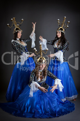 Trio of oriental dancers with candelabras