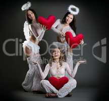 Studio shot of beautiful girls posing as cupids