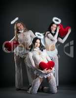 Cute female dancers posing in cupid's costumes