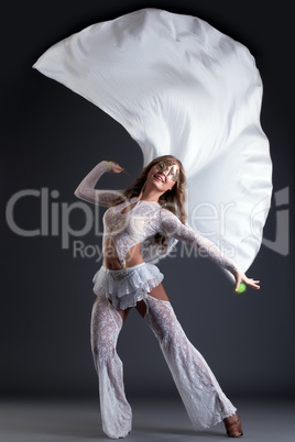 Shot of cheerful young woman dancing with cloth