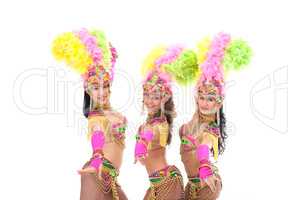 Trio of artistic samba dancers smiling at camera
