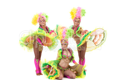 Energetic young girls dancing in carnival costumes