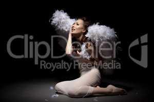 Studio shot of crying lovely girl dressed as angel