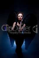 Beautiful model posing in suit of fallen angel