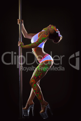 Excited young pole dancer posing with UV makeup