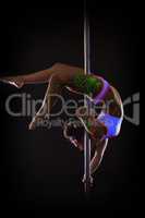 Attractive girl dancing on pole upside down