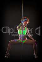 Sexy pole dancer posing with luminous UV makeup