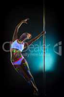 Amazing slim woman with UV makeup dancing on pole