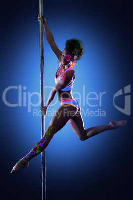 Sexy pole dancer posing with ultraviolet makeup