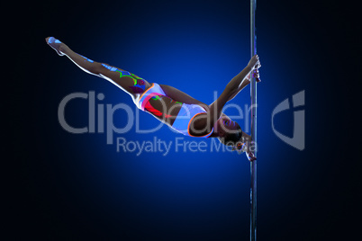 Athletic young woman posing doing splits on pylon