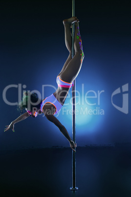 Image of athletic young girl dancing on pole