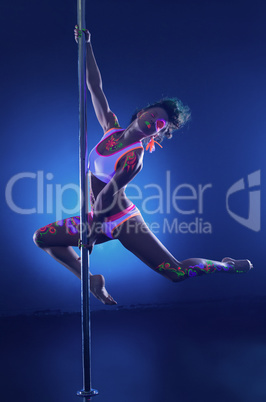 Beautiful muscular dancer posing with neon makeup