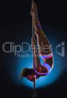 Elegant young pole dancer posing with UV makeup