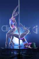 Studio shot of sexy young pole dancers
