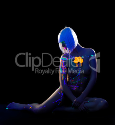 Attractive naked girl posing under neon light