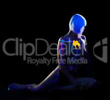 Seductive nude girl posing under fluorescent light