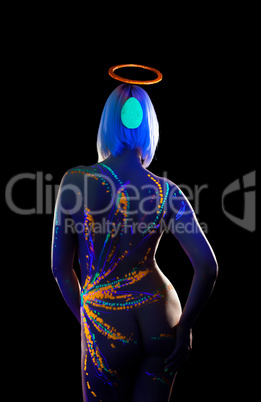 Girl with UV pattern on body posing back to camera