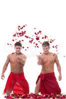 Beautiful muscular young men throw rose petals