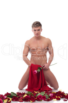 Sexy naked guy posing in studio with roses