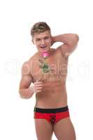 Image of merry muscular man posing with rose