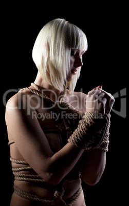 Portrait of beautiful nude blonde with hands bound