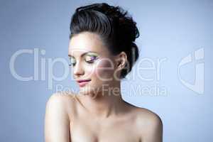 Pretty girl with evening make-up posing in studio