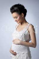 Sensual pregnant woman posing in trendy dress