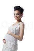 Pretty pregnant woman posing in fashionable dress