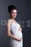 Charming expectant mother posing looking at camera