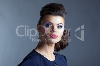 Cute model with evening make-up posing at camera