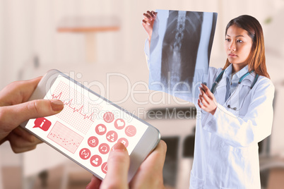 Composite image of asian doctor checking mri scan