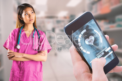 Composite image of asian nurse crossing arms