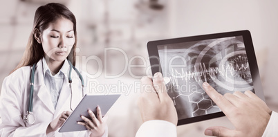 Composite image of asian doctor using tablet