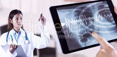 Composite image of asian doctor pointing with pen